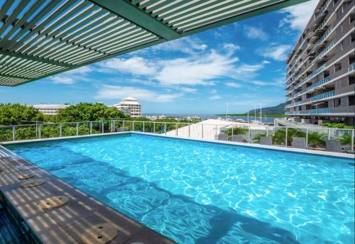 a swimming pool on the roof of a building at 1101 Harbour Lights with Ocean Views in Cairns