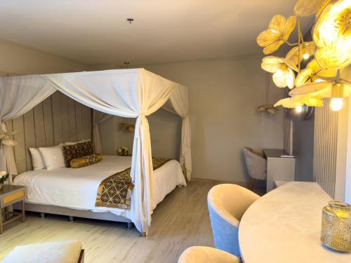 a bedroom with a bed with a canopy at Hotel Catedral Plaza in Santa Marta