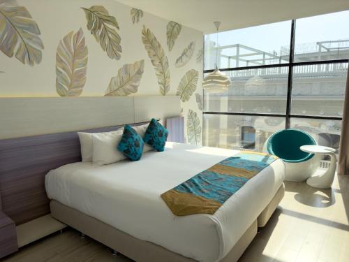 Cama ou camas em um quarto em Hotel Catedral Plaza