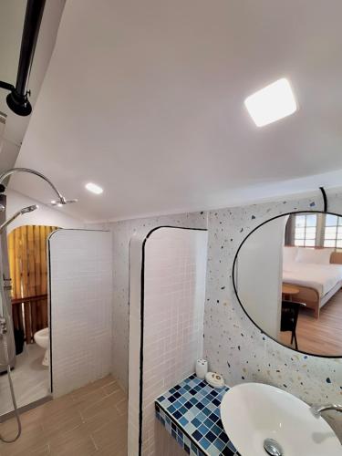 a bathroom with a sink and a mirror at PAN Beachfront Resort Krabi in Klong Muang Beach