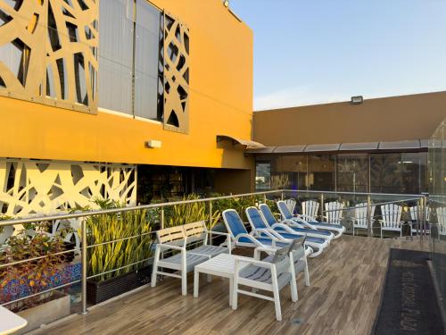 a row of chairs on the balcony of a building at Hotel Catedral Plaza in Santa Marta