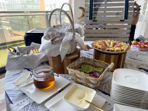 a table topped with food and baskets of food at Hotel Catedral Plaza in Santa Marta