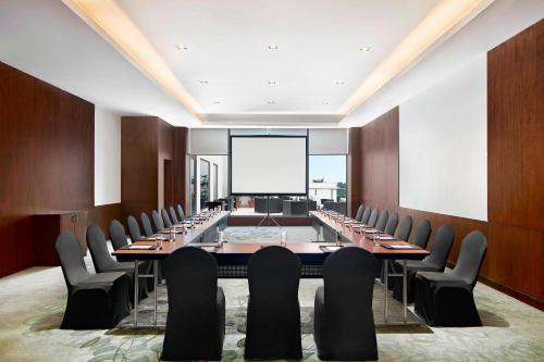 a large conference room with a long table and chairs at The Westin Kolkata Rajarhat in Kolkata