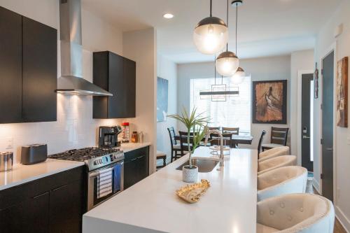 a kitchen with a white counter top and a table at Luxury Townhome Skyline Views Mins To DT in Nashville