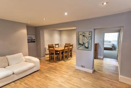 a living room with a white couch and a table at Charming Apartment in Deal near the Beach & Town in Kent