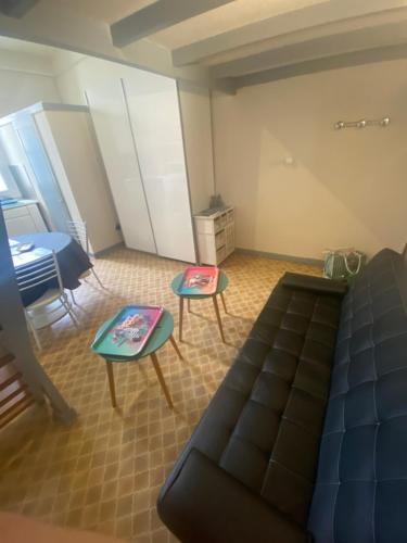 a living room with a couch and two tables at Studio Remblai LS in Les Sables-d'Olonne