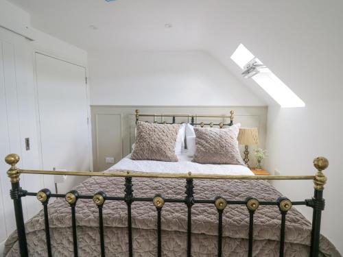a bedroom with a bed with a metal frame at The Old Stable in Tondu