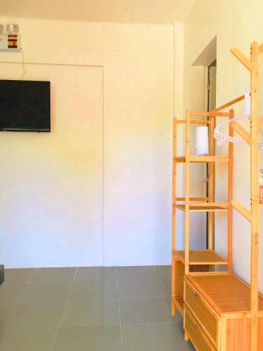 a room with a book shelf and a tv at Victoria's Inn by Martha Vacation Homes in Boracay