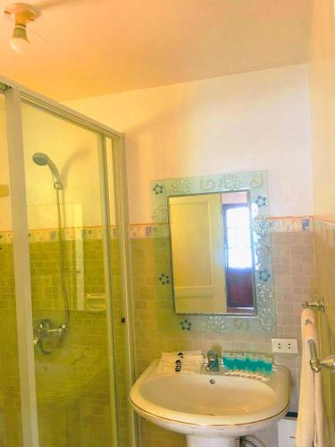 a bathroom with a sink and a shower at Victoria's Inn by Martha Vacation Homes in Boracay
