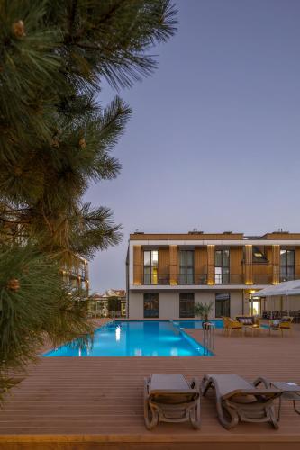 a hotel with a swimming pool in front of a building at Hotel Saltic Resort & Spa Grzybowo in Kołobrzeg