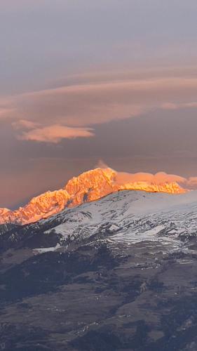 a view of a snow covered mountain from an airplane at Ca' De Sass in Pila