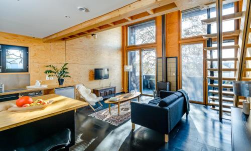 un salon avec une table, des chaises et des fenêtres dans l'établissement Kabane 49, à Niort