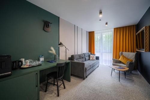 a living room with a couch and a table at Kompleks Antałówka Termy & Med in Zakopane