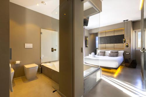 a hotel room with a bed and a bathroom at Milestone in Quartu SantʼElena