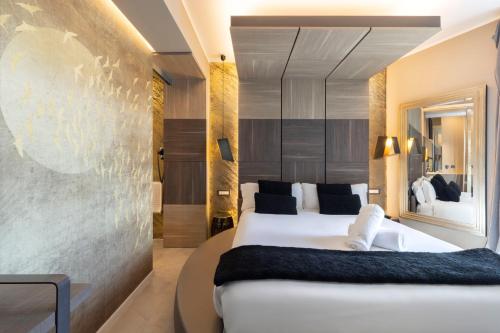 a bedroom with a large white bed in a room at Milestone in Quartu SantʼElena