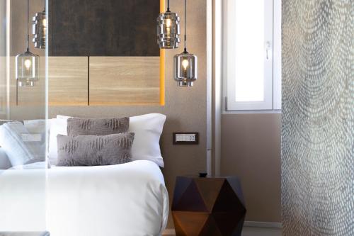 a bedroom with a bed and a window and lights at Milestone in Quartu SantʼElena