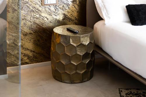 a side table next to a bed in a room at Milestone in Quartu SantʼElena