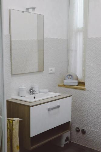 a bathroom with a sink and a mirror at La Casa di Piccolì di Gabriele Martelli e Catia Pacetti - Camera FARFALLA in Ancona