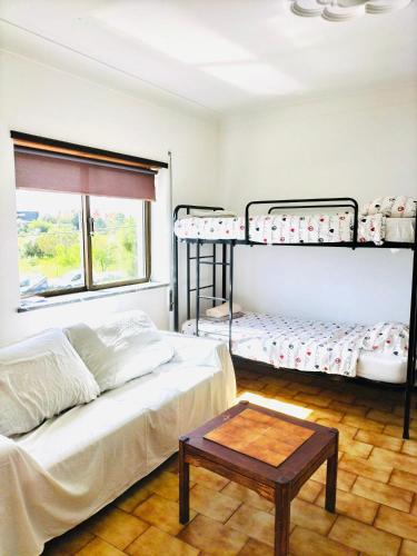 a room with two bunk beds and a coffee table at Portimao central Holiday Hostel ,Algarve in Portimão