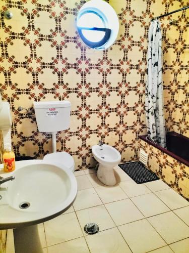 a bathroom with a toilet and a sink at Portimao central Holiday Hostel ,Algarve in Portimão