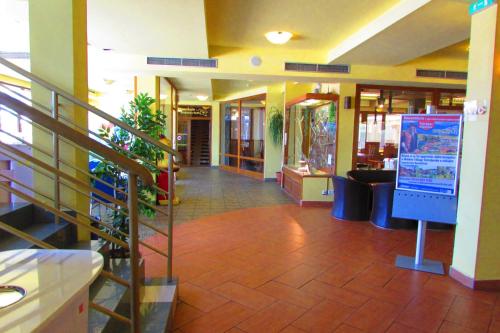 a hallway of a store with a staircase and a lobby at Chata u vinára Milana, Tatralandia in Liptovský Mikuláš
