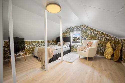 a bedroom with a bed and a couch and a chair at AA Home Solgryveien Harstad in Harstad