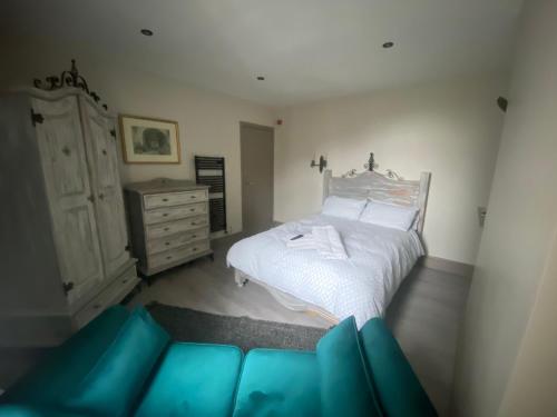 a bedroom with a white bed and a dresser at Just the tonic in Nottingham