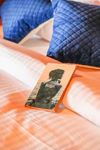 a book sitting on top of a bed at Sajeev Home Stay in Cherai Beach