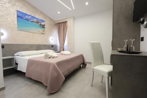 a hotel room with a bed and a chair at B&B Sunlight Tropea in Tropea