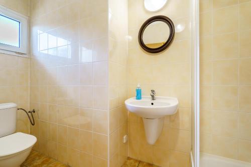 a bathroom with a sink and a toilet and a mirror at BeachCamp Nová Role in Nová Role