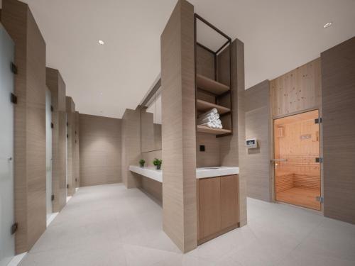 a hallway with wooden walls and a sink and a mirror at Holiday Inn Shijiazhuang High-tech Zone, an IHG Hotel in Shijiazhuang