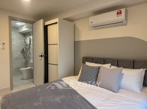 een slaapkamer met een groot bed en een badkamer bij Arte Cheras KL Nordic Design Duplex by Nexstay in Kuala Lumpur
