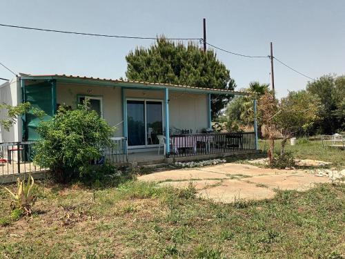 a small house with a porch and a patio at Mazotos beach house in Mazotos