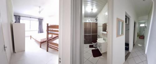 a bathroom with a sink and a toilet in a room at Apartamento Peruibe pé na areia!!! in Peruíbe