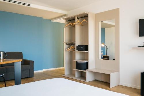 a living room with a mirror and a couch at Encanto Agriturismo & Private SPA in Visogliano