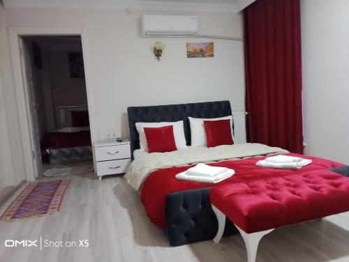 a bedroom with a large bed with red pillows at ÇARŞI HOTEL&CAFE in Trabzon
