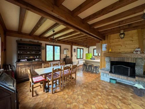 Il comprend une cuisine et une salle à manger avec une table et une cheminée. dans l'établissement Chalet cosy au pied du Mont Blanc, aux Houches