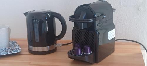 affeepot and a coffee maker sitting on a table at AGORA CENTER Building - Room 20 in Ios Chora