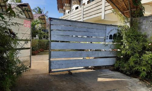 a blue wooden gate in front of a building at Point F Siargao in Catangnan