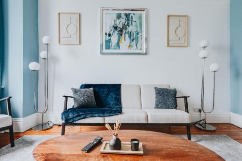 a living room with a couch and a table at City Park View Manchester in Manchester