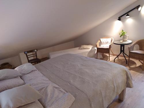 a bedroom with a bed and a table and chairs at Chalupa u Pramenů in Počátky