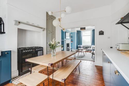 a kitchen and dining room with a wooden table at City Park View Manchester in Manchester