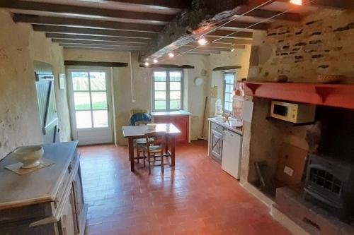 a kitchen with a table and chairs in a room at Gîte Samaret Gers en Gascogne in Lagardère