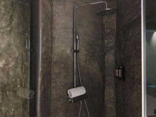 a shower with a glass door with a towel at Casa da Calçada in Maceira