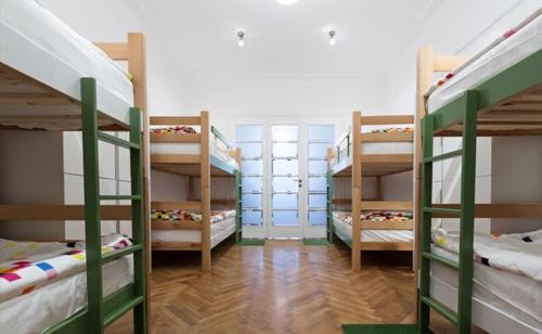 a room with three bunk beds in a room at Levi Home Guest House & Retreat Centre in Siliguri