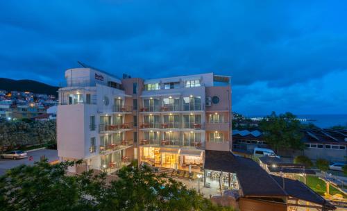 a large white building with lights on at Family Hotel Berlin Beach Sveti Vlas in Sveti Vlas