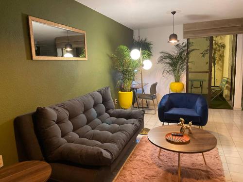 a living room with a couch and a table at House Near The Santiago River in San Luis Potosí