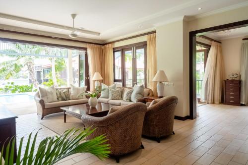 a living room with couches and a table at Maison L'Amirale by Simply-Seychelles in Eden Island