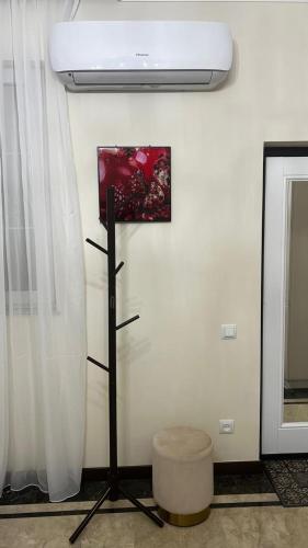 a room with a ceiling fan and a painting on the wall at Mont Blanc Art apartments in Yerevan