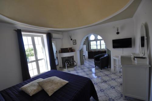 a bedroom with a bed and a living room at Villa Eva in Anacapri